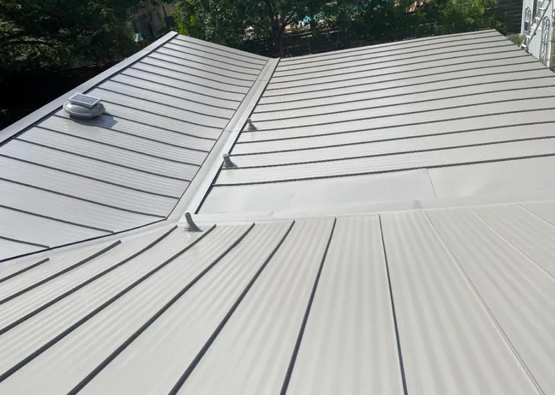 Solar attic fan installed on a metal roof for Roof Ventilation in Isanti